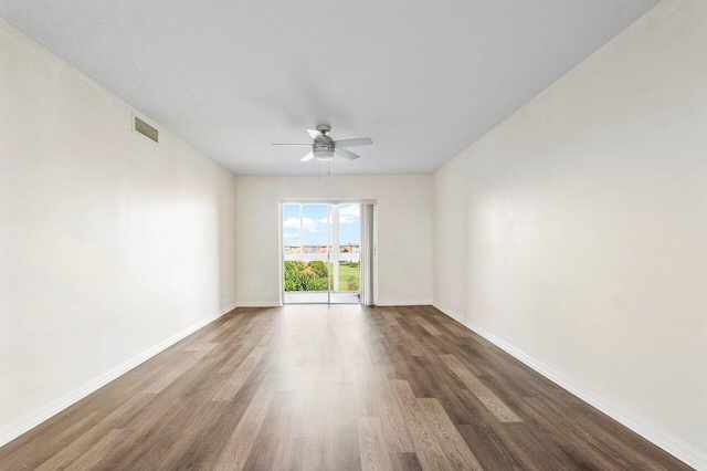 empty room featuring ceiling fan and dark hardwood / wood-style floors