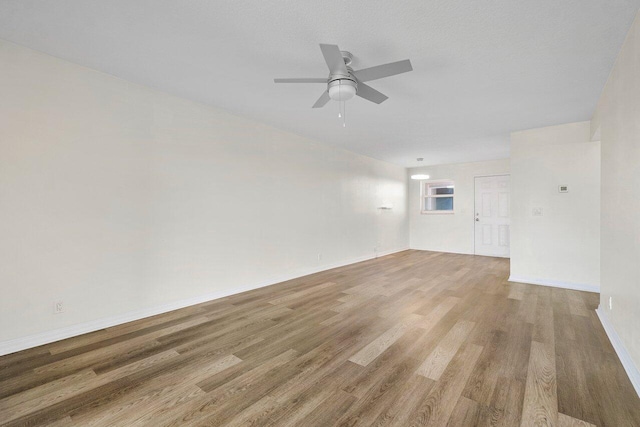 empty room featuring ceiling fan and hardwood / wood-style floors