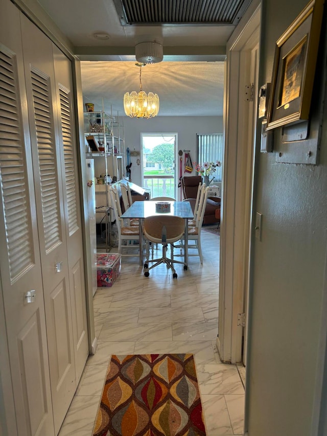 tiled dining room with an inviting chandelier