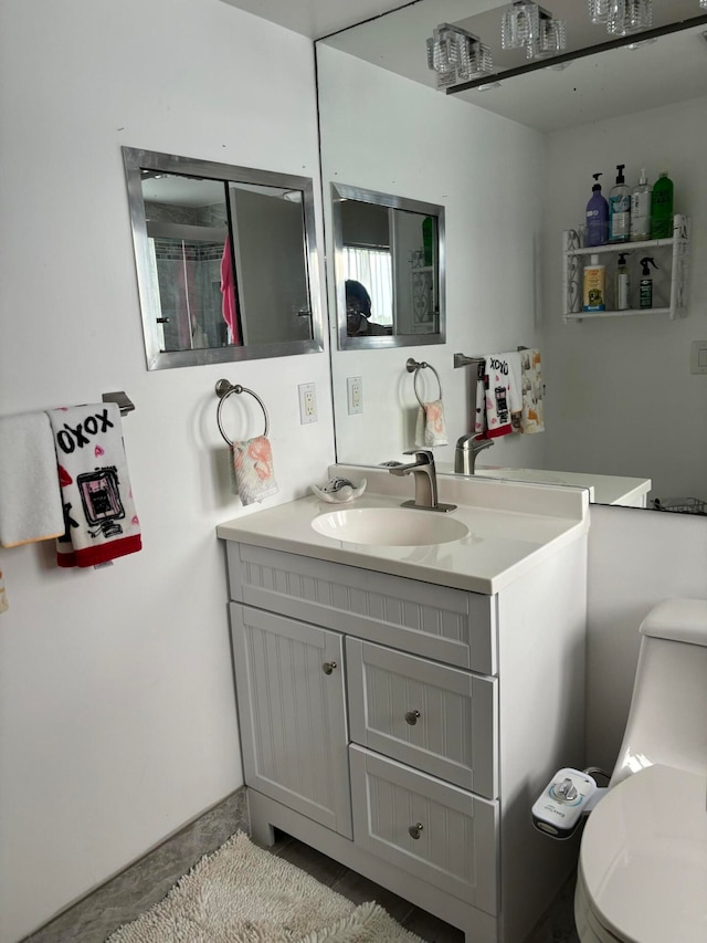 bathroom featuring vanity and toilet