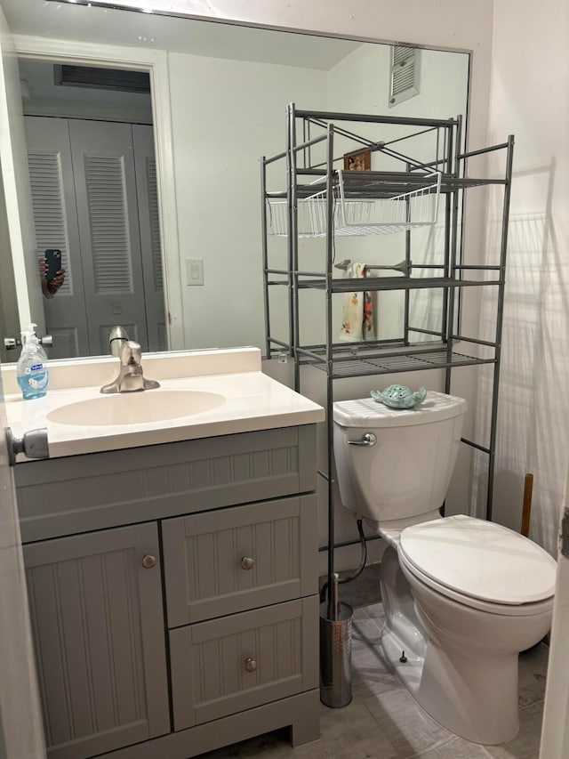 bathroom featuring toilet and vanity