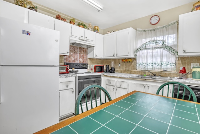 kitchen with sink, white cabinets, backsplash, and white appliances