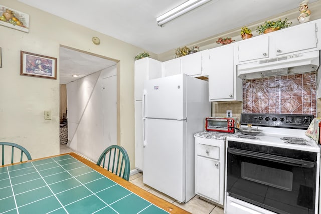 kitchen with light tile patterned flooring, tasteful backsplash, white appliances, and white cabinets