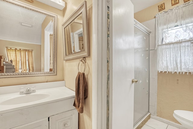 bathroom featuring a shower with door, tile patterned flooring, a textured ceiling, toilet, and vanity