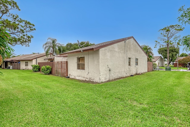 rear view of property with a lawn