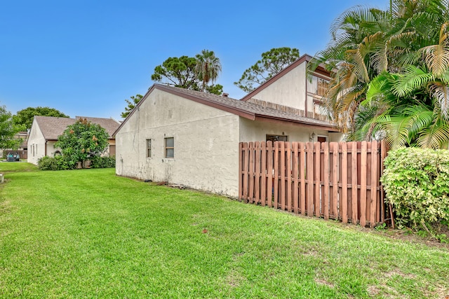 view of side of property with a lawn