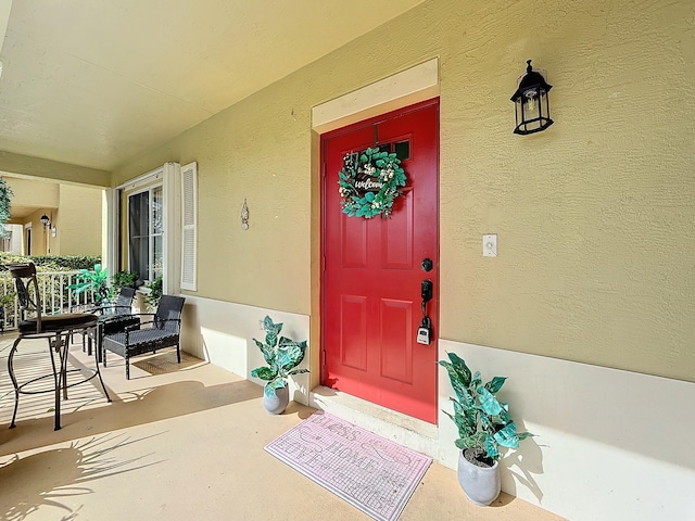 doorway to property featuring covered porch