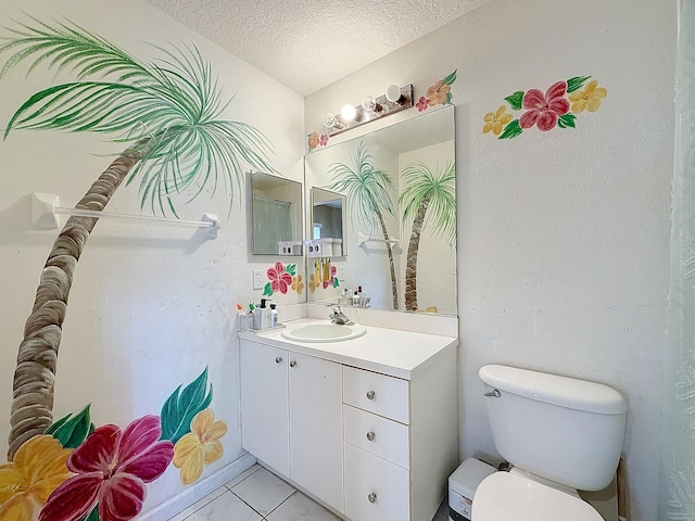 bathroom featuring tile patterned floors, vanity, toilet, and a textured ceiling