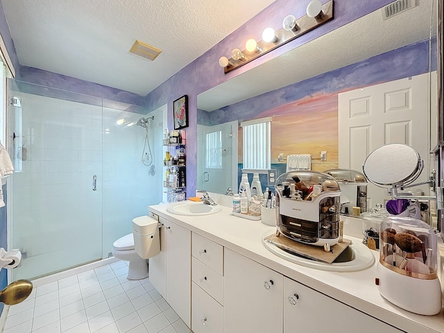 bathroom featuring walk in shower, tile patterned flooring, a textured ceiling, toilet, and vanity