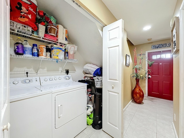 laundry room with washer and dryer and light tile patterned flooring