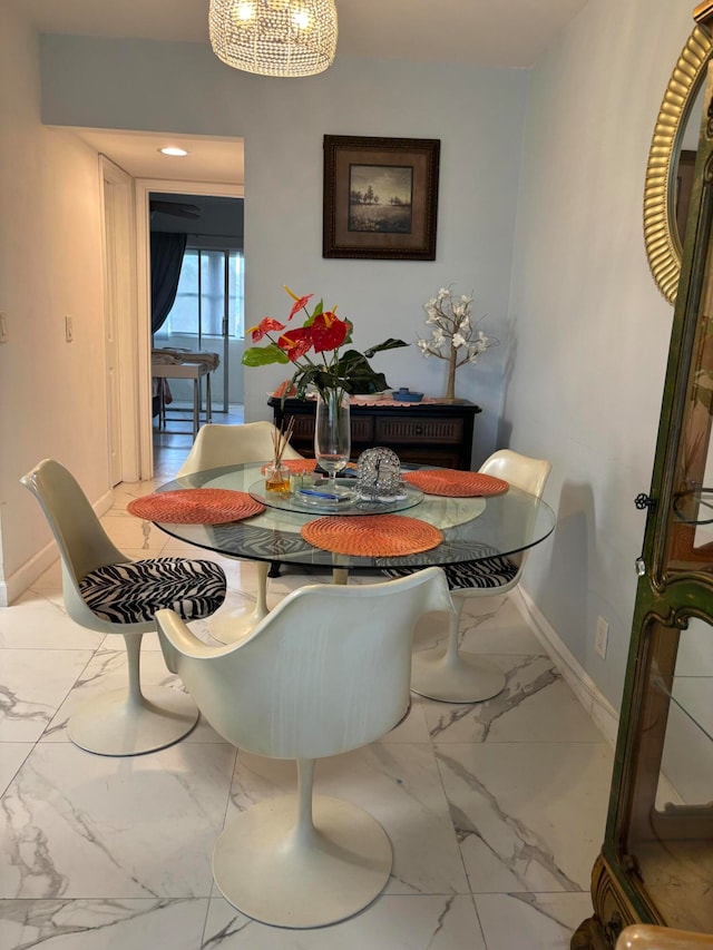 dining space featuring tile patterned floors and a chandelier