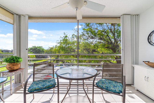 sunroom / solarium featuring ceiling fan