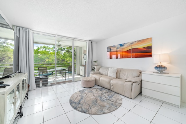 living room with a wall of windows, light tile patterned floors, and a textured ceiling