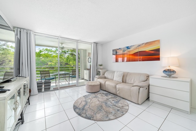 tiled living room featuring expansive windows and a textured ceiling