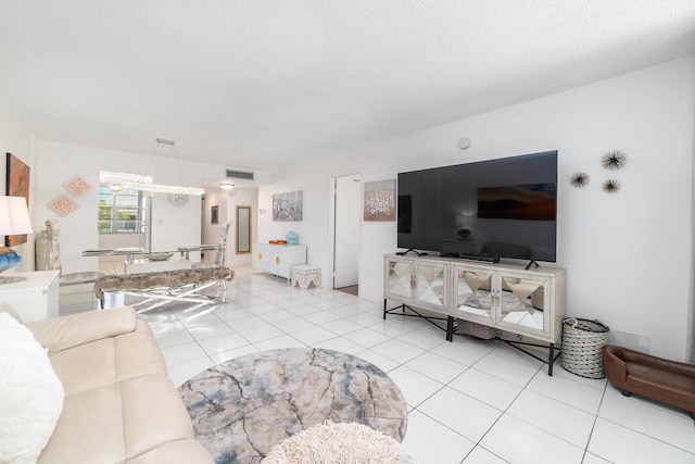 living room featuring light tile patterned floors and a textured ceiling