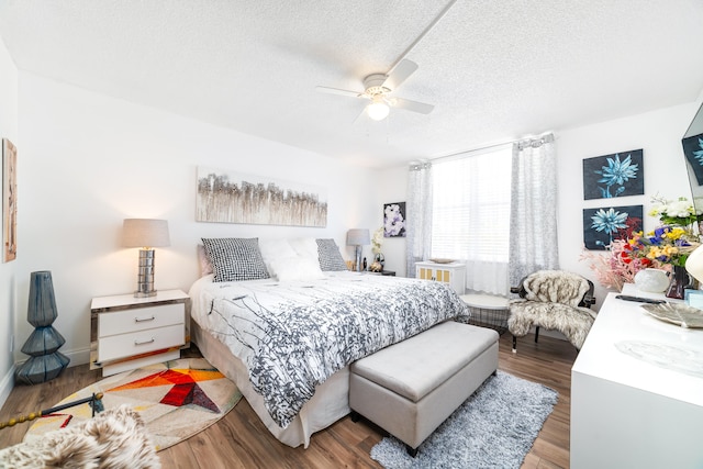 bedroom featuring a textured ceiling, hardwood / wood-style floors, and ceiling fan