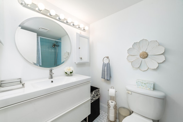 bathroom featuring vanity, tile patterned flooring, and toilet