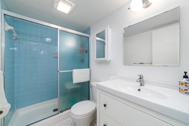 bathroom with a shower with door, vanity, and toilet