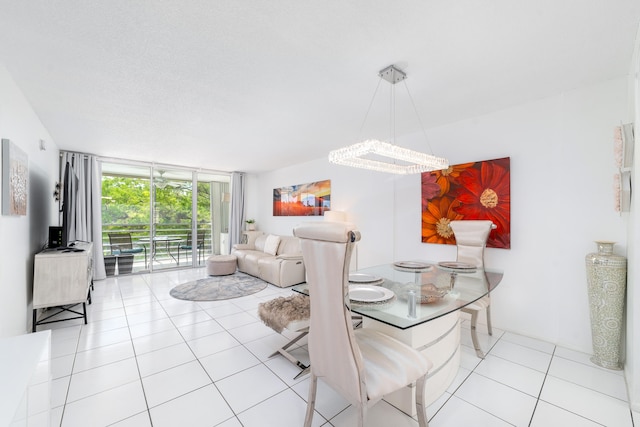 dining room featuring light tile patterned flooring, expansive windows, and a chandelier