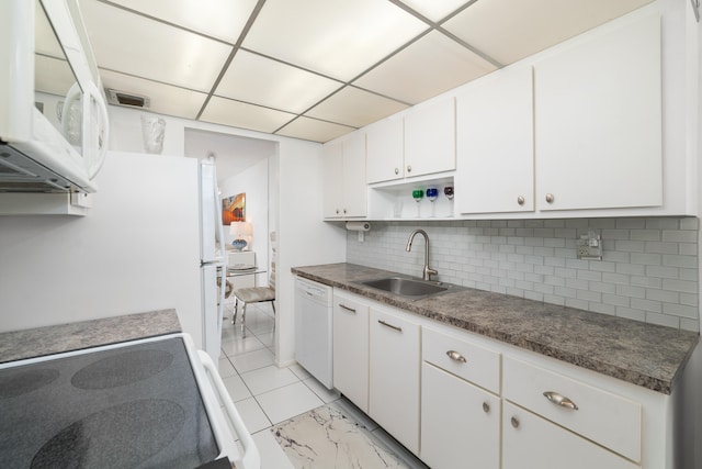 kitchen with white cabinetry, white appliances, light tile patterned floors, decorative backsplash, and sink