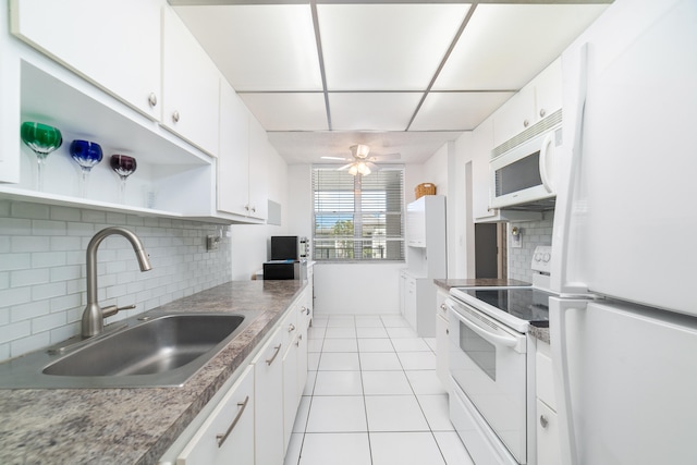 kitchen with light tile patterned flooring, ceiling fan, white cabinets, white appliances, and sink