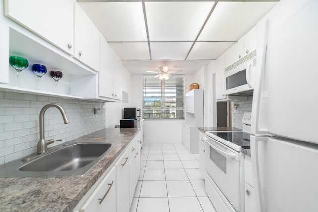 kitchen featuring light tile patterned flooring, sink, ceiling fan, white appliances, and white cabinets