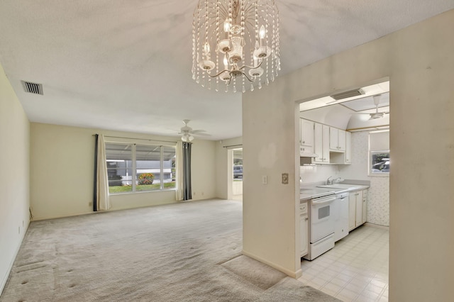 kitchen with white electric range oven, light colored carpet, ceiling fan with notable chandelier, white cabinets, and ventilation hood