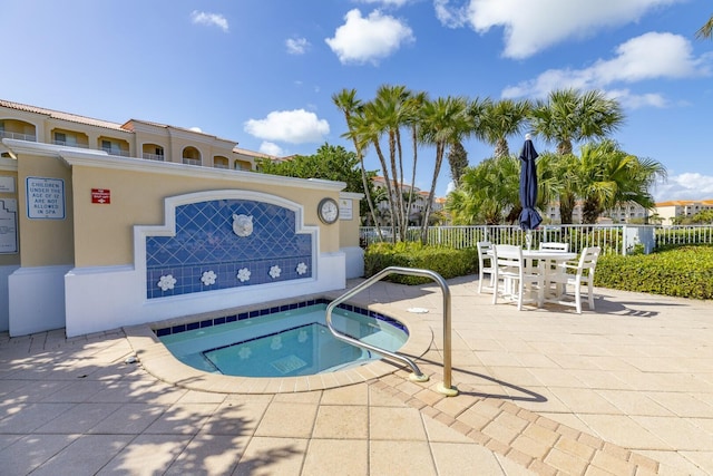 view of pool featuring a patio area and a community hot tub