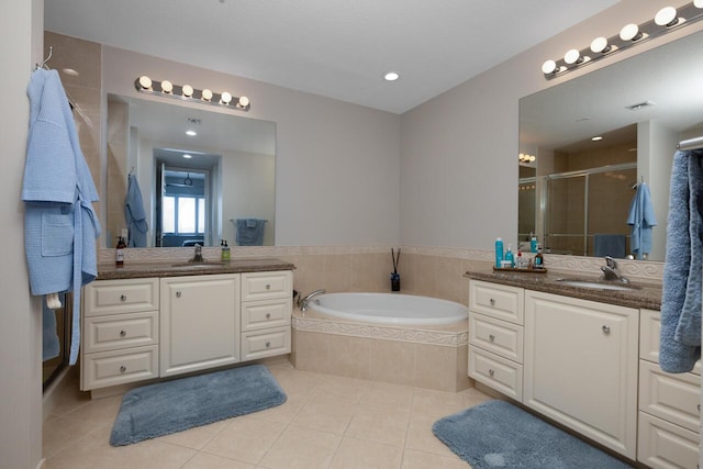 bathroom featuring tile patterned flooring, vanity, and plus walk in shower