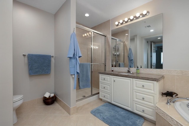 full bathroom featuring vanity, tile patterned floors, toilet, and separate shower and tub