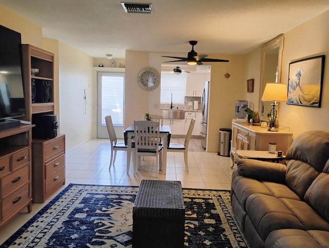 tiled living room with sink and ceiling fan