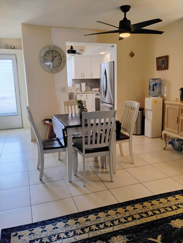 tiled dining room with ceiling fan