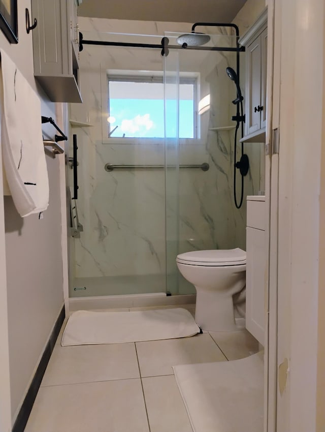 bathroom with toilet and tile patterned flooring