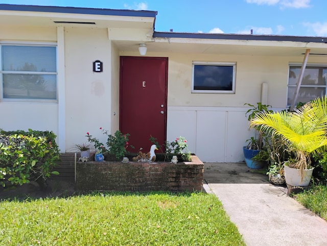 entrance to property with a yard