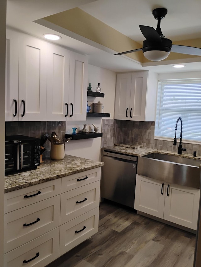 kitchen featuring ceiling fan, white cabinets, decorative backsplash, hardwood / wood-style floors, and dishwasher