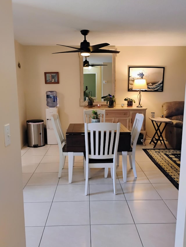 tiled dining area with ceiling fan