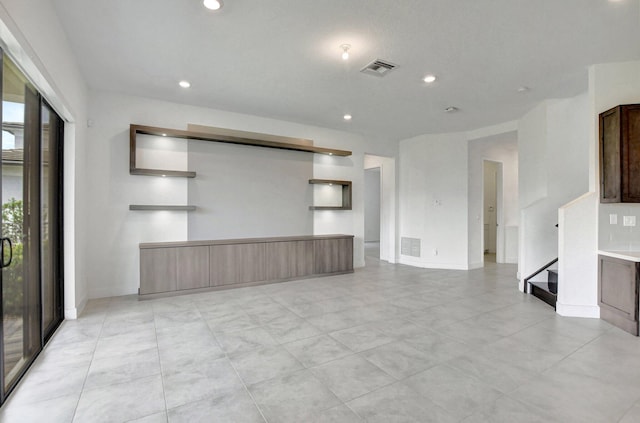 unfurnished living room featuring light tile patterned flooring