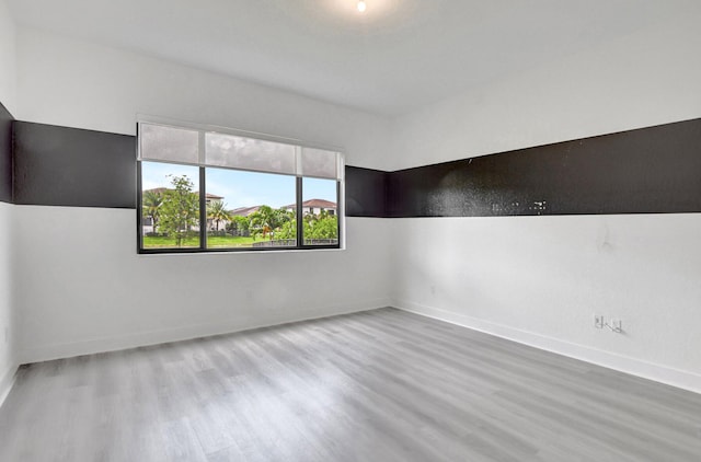 spare room featuring hardwood / wood-style flooring