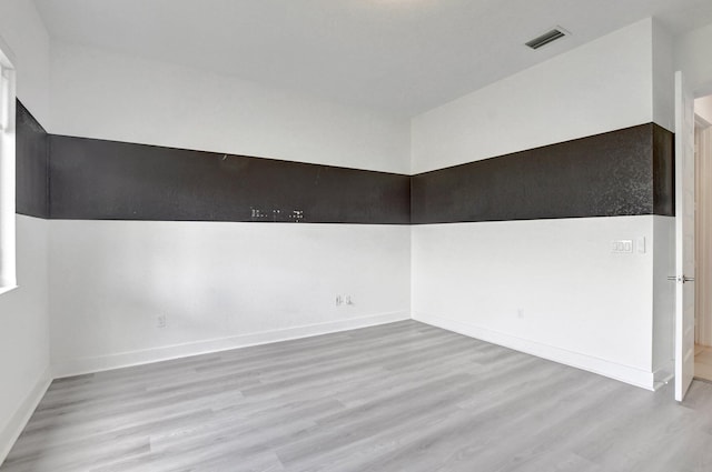 unfurnished room featuring hardwood / wood-style flooring