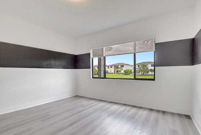 unfurnished room with hardwood / wood-style floors