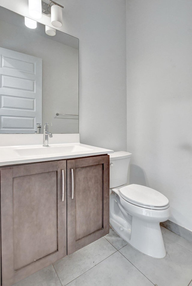 bathroom with tile patterned floors, vanity, and toilet