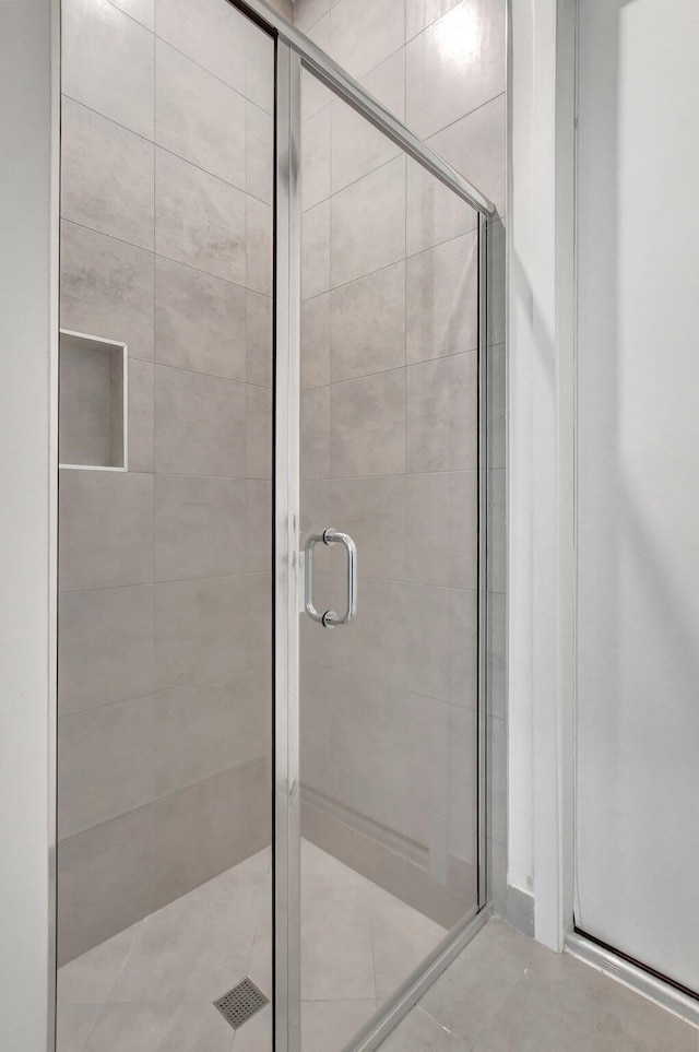 bathroom featuring a shower with shower door