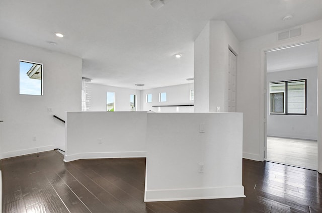 kitchen with dark hardwood / wood-style flooring and kitchen peninsula