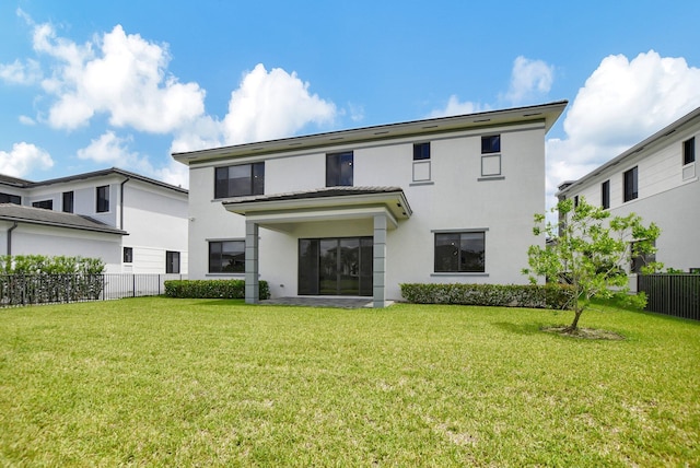 back of house featuring a yard