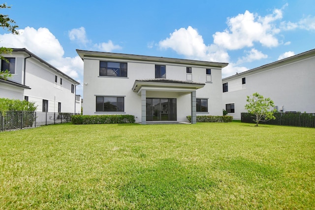 rear view of property featuring a yard