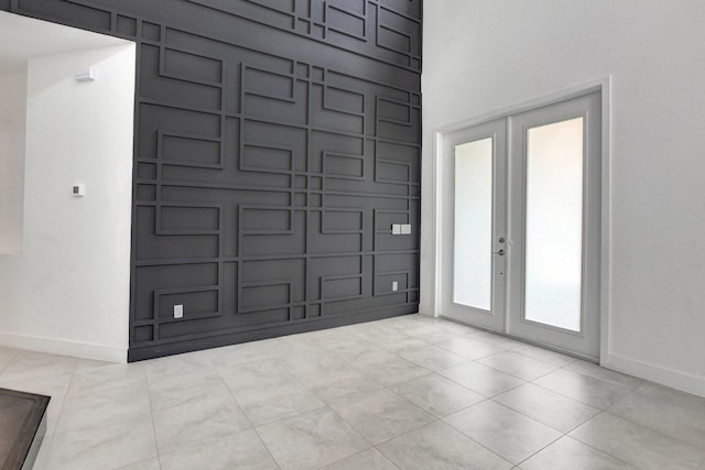 foyer with french doors and light tile patterned floors