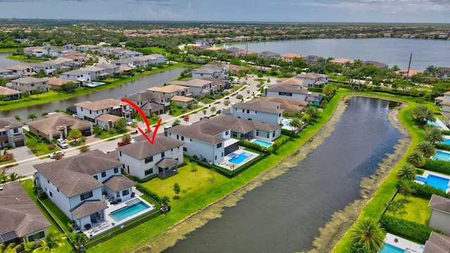 birds eye view of property with a water view