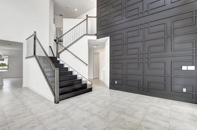 foyer entrance featuring a high ceiling and light tile patterned floors