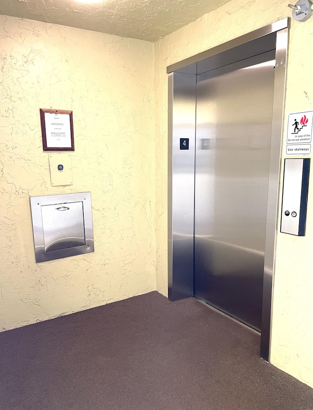 interior space featuring elevator and carpet flooring