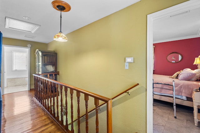 hallway featuring crown molding and tile patterned flooring